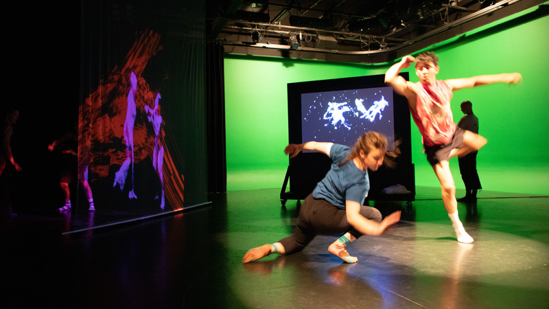 a pair of students in dance poses in ARTSLab as part of Dance Hackathon