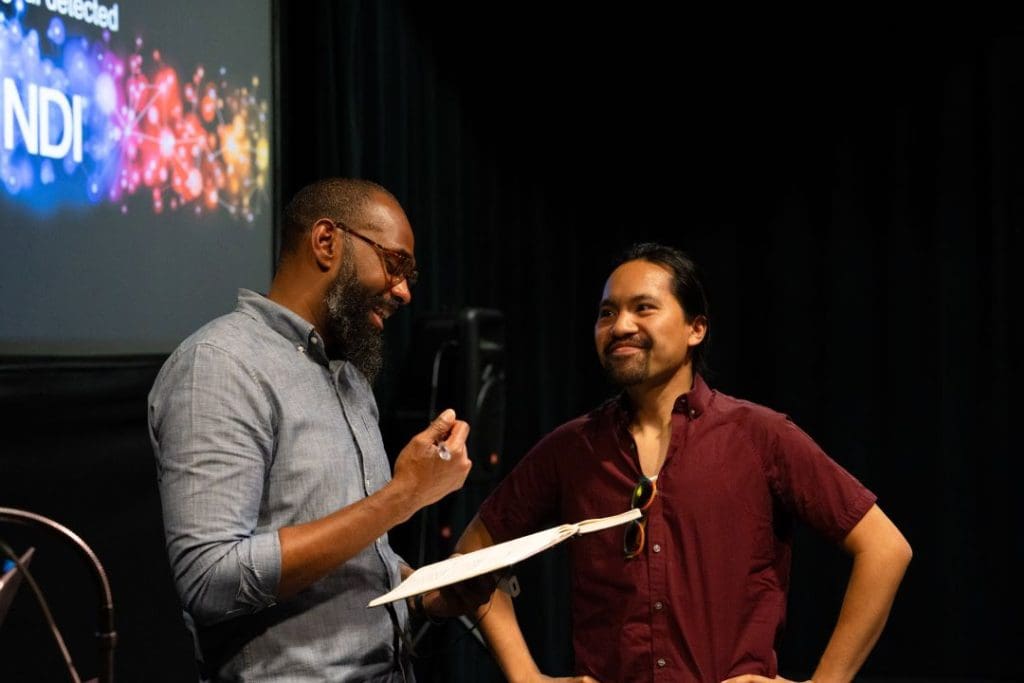 Two men talking on stage