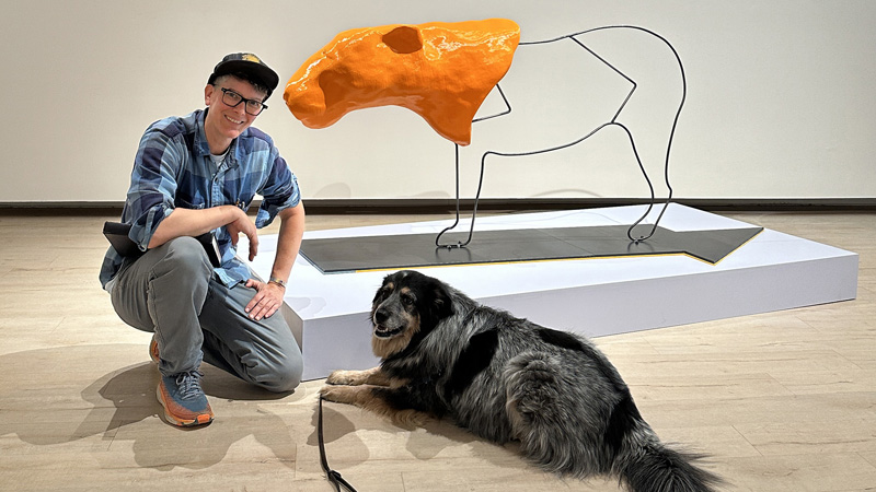 Welly Fletcher poses with her dog and new 3D printed sculpture